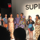 The winning designer with her five looks. The one on the far left features a self-portrait. Second from left features the Mona Lisa.